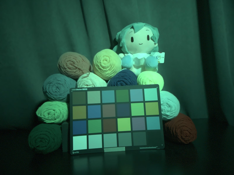 rolled towels and a plush toy under teal LED