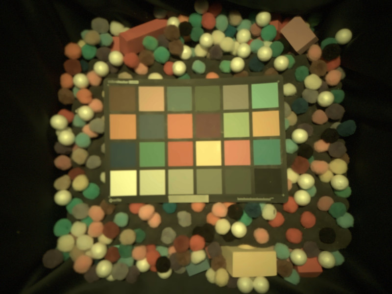 craft pom-poms surrounding a ColorChecker